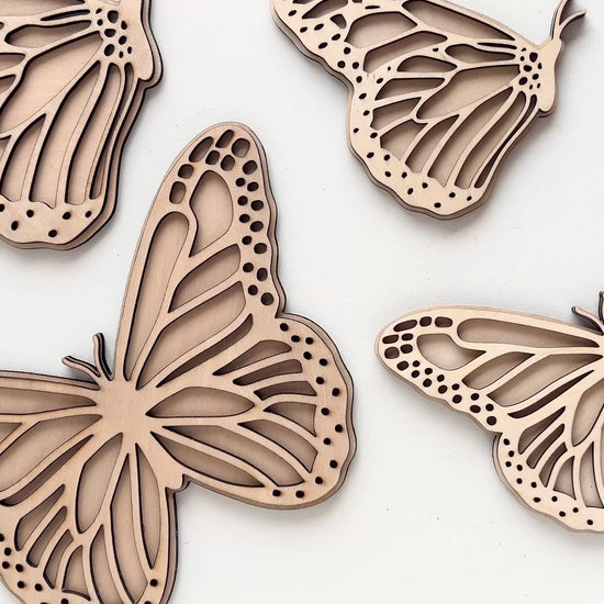 Video showing the mini, standard and large sizes of the Set of 2 Butterfly wall art, one with open wings and one closed. Perfect for a girls bedroom, playroom or nursery. This kids decor is made from laser cut wood and double layered. 