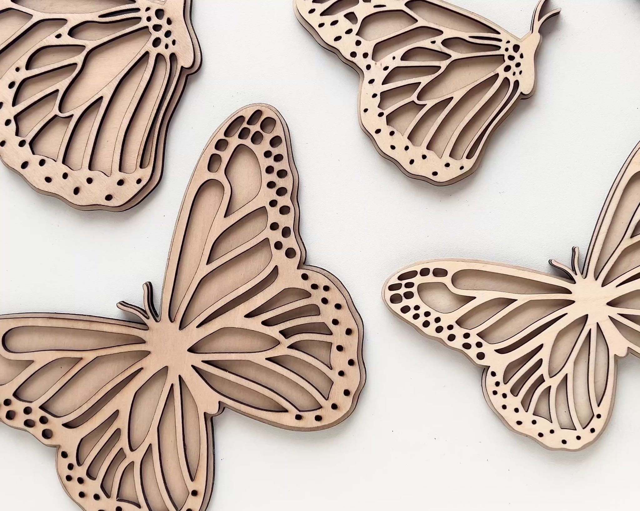Video showing the mini, standard and large sizes of the Set of 2 Butterfly wall art, one with open wings and one closed. Perfect for a girls bedroom, playroom or nursery. This kids decor is made from laser cut wood and double layered. 